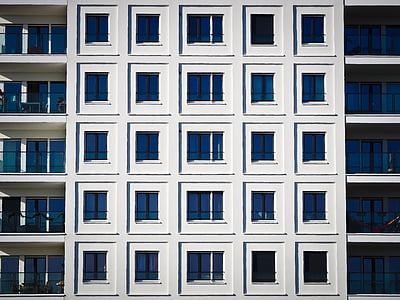 architectural photography of white and blue concrete building thumbnail