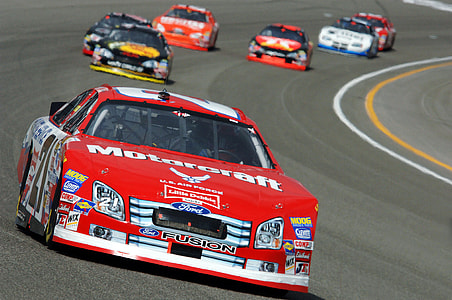 red stock cars on race track thumbnail