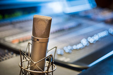 selective focus photography of condenser microphone near mixing console thumbnail