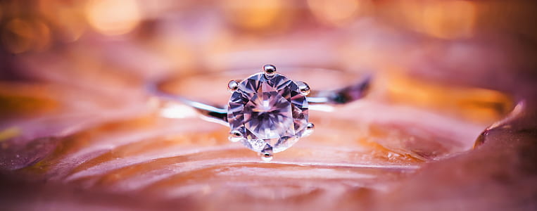 selective focus photography of silver ring with round-cut diamond gemstone thumbnail