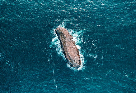 aerial photography of rock formation at sea thumbnail