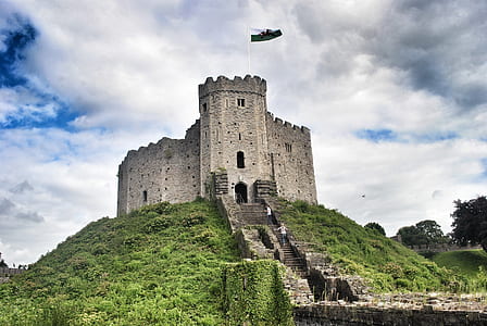 photography of gray castle on top of mountain during daytime thumbnail