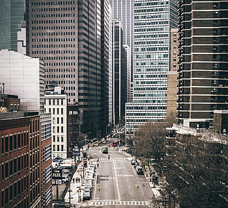 gray concrete road top between city buildings during daytime thumbnail