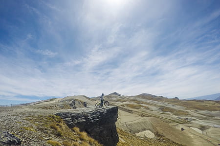 person riding bicycle on top of the cliff thumbnail