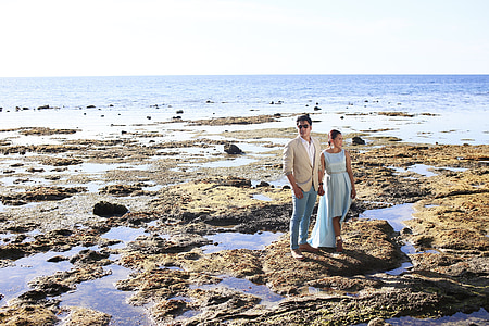 man and woman standing on seashore thumbnail
