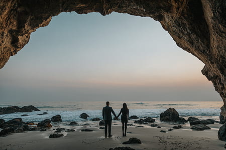 man and woman standing next to each other near shore thumbnail