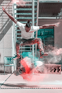 man doing flip trick with skateboard and smoke thumbnail