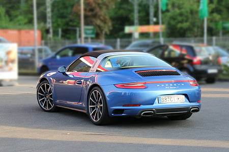 blue Porsche 911 Spyder coupe on road thumbnail