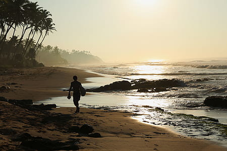 male surfer walking on seashore thumbnail