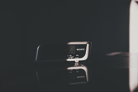 white and black Sony electronic device on top of black surface thumbnail