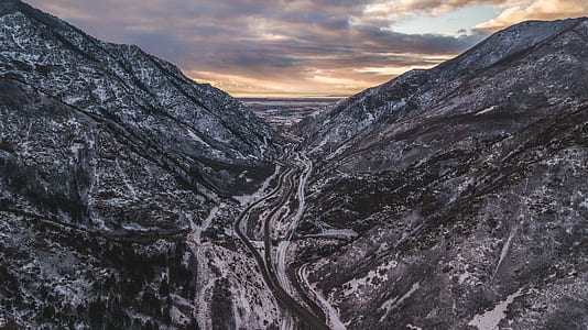 body of water in between mountains thumbnail