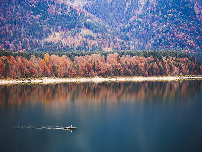 person riding boat on body of water thumbnail