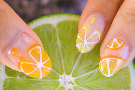 woman with orange fruit nail art thumbnail