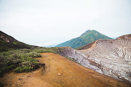 Green hills and deserted rock mountains with hikers thumbnail