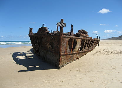 brown metal ship wrecked on seashore thumbnail