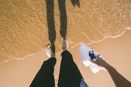 Photo of Person Holding Sneakers thumbnail