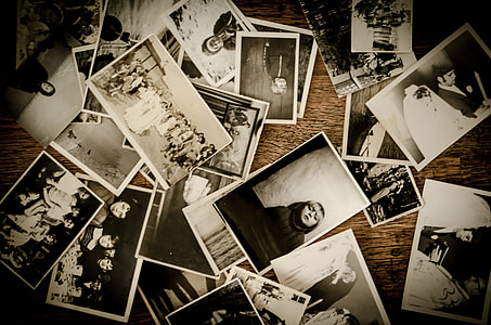 assorted black and white photo lot on brown wooden surface thumbnail