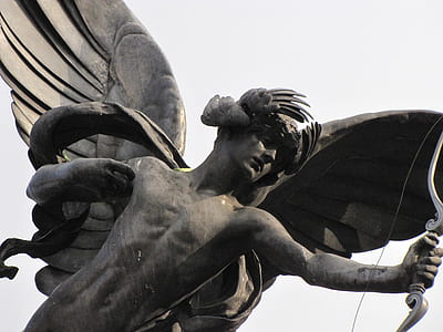 cupid statue near white surface thumbnail
