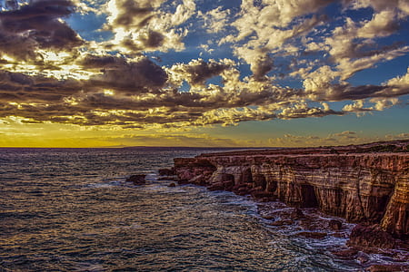 brown cliff near ocean thumbnail