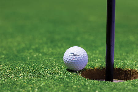 Titrist Golf Ball Near Golf Hole thumbnail