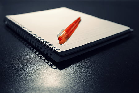 orange click pen on notebook thumbnail