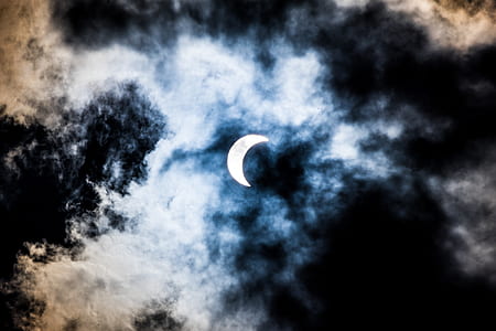 crescent moon during cloudy sky thumbnail