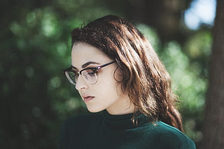 brown haired woman in green top and eyeglasses thumbnail
