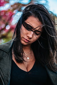 woman with black hair bowing her head thumbnail