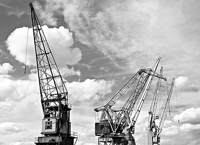 grayscale photography of industrial cranes thumbnail
