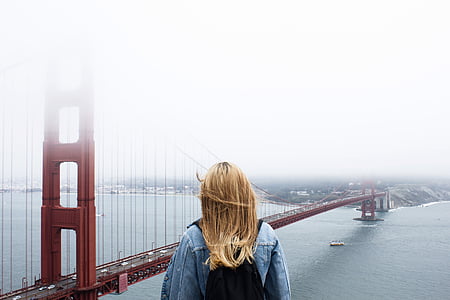 woman standing near golden gate bridge thumbnail