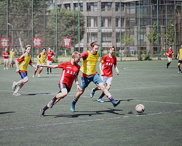 players playing soccer during daytime thumbnail