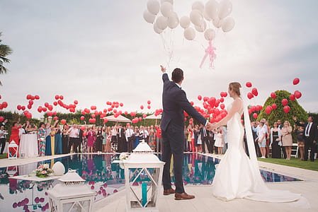 newlywed couple beside pool under cloudy sky during daytime thumbnail