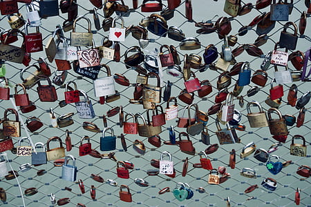 assorted padlocks on fence thumbnail