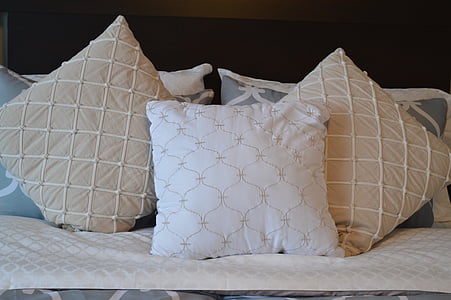 three brown-and-white throw pillows thumbnail