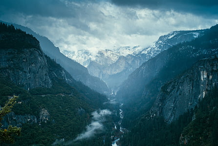 river between mountain range under gray clouds thumbnail