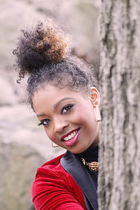 woman wearing black and red coat smiling at the camera thumbnail