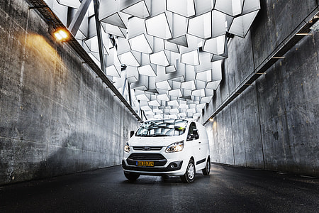 photo of white Ford van in a middle of concrete walls thumbnail