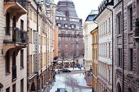 two building with snow during daytime thumbnail