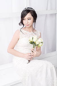 woman bride holding a bouquet of white roses thumbnail