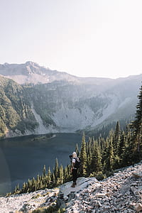 person standing on gray rock during daytime thumbnail