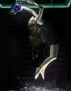 woman in water holding silver steel desk clock thumbnail