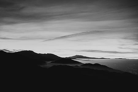 sepia photo of mountains and body of water thumbnail