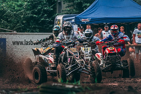 four persons riding on ATV quad bikes thumbnail