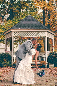 man kissing woman in front of white gazebo thumbnail
