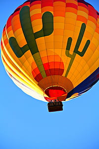 photo of yellow, red, and blue hot-air balloon in flight thumbnail