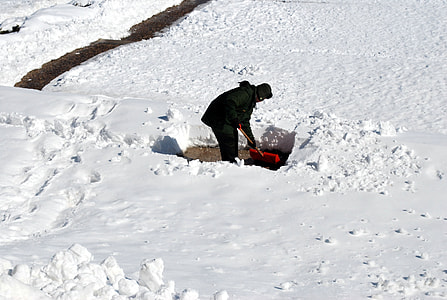 man shoveling snow during daytime thumbnail
