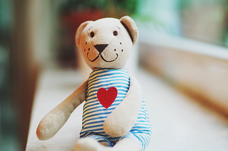 beige bear wearing blue rompers plush toy close-up photography thumbnail