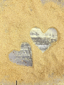 two hearts cut out on brown sand thumbnail