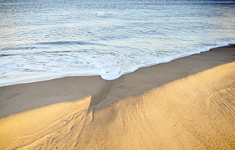 photography of brown sand near beach at daytime thumbnail