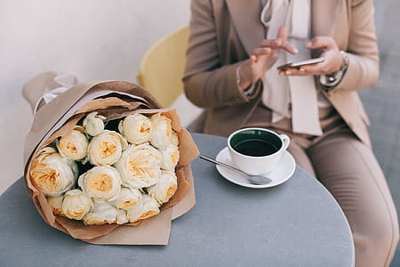 Bouquet of White Roses Beside Cup of Tea thumbnail